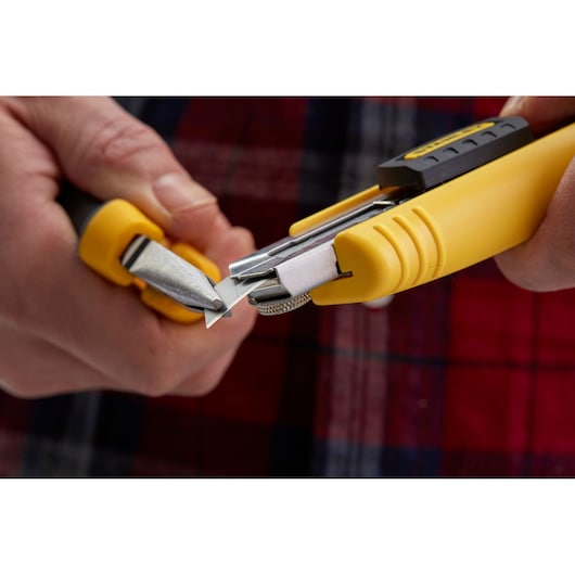 STANLEY 0-10-481 utility knife close-up with yellow handle, blade snapping demonstration.