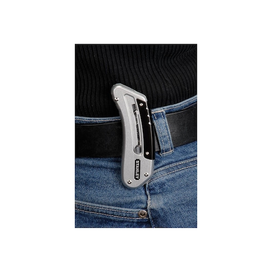 STANLEY 0-10-810 folding utility knife clipped on a jeans belt, close-up view.