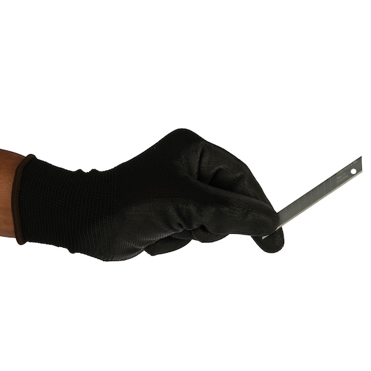 Stanley 0-11-300 utility blade held by gloved hand, side angle, photography of product.