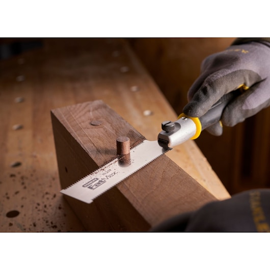 STANLEY 0-20-331 flush cut saw cutting wooden dowel on workbench, close-up angle.