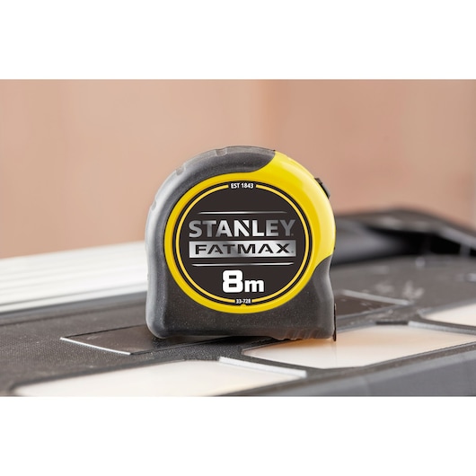 STANLEY 0-33-728 FATMAX 8m tape measure with yellow and black casing, side photography.