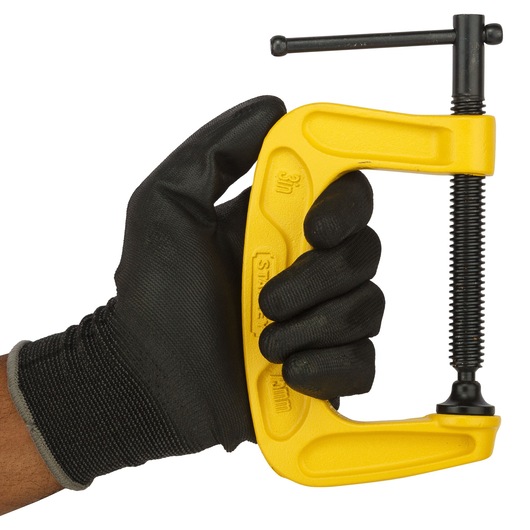 Stanley 0-83-033 C-clamp, yellow, held in gloved hand, side angle, photography.