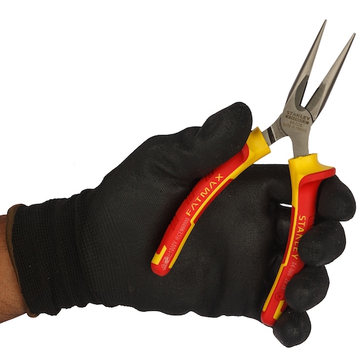 STANLEY 0-84-006 long nose pliers with red and yellow handles held in a black gloved hand, side angle.