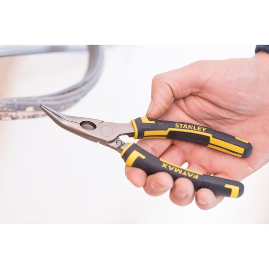 STANLEY 0-89-871 long nose pliers with black and yellow FATMAX grips, held in hand, side angle.