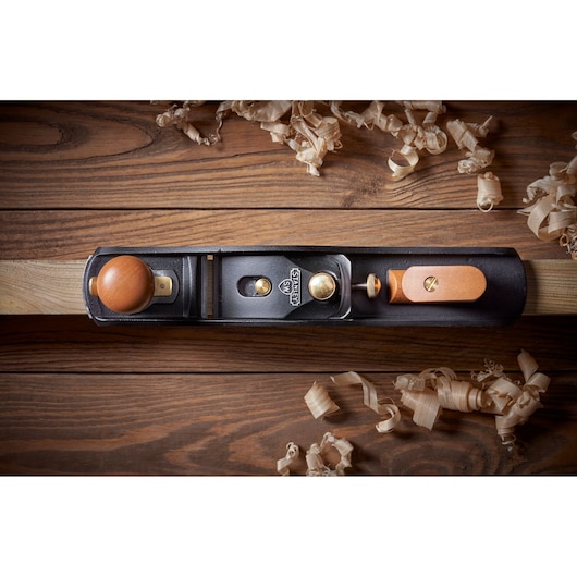 STANLEY 1-12-137 hand plane top view on wood surface with wood shavings, photography product.
