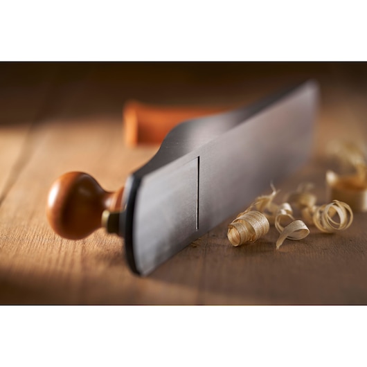 STANLEY 1-12-137 hand plane with wood handle on table, shavings nearby, angled side view.