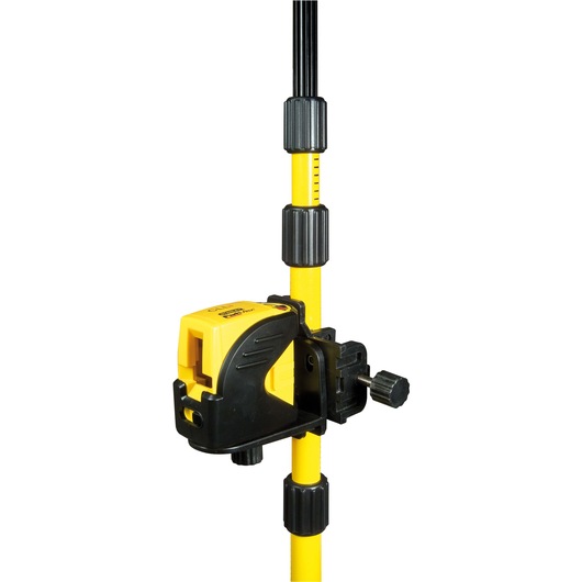 Yellow STANLEY laser level attached to an adjustable tripod pole for precise photography or measuring tasks.