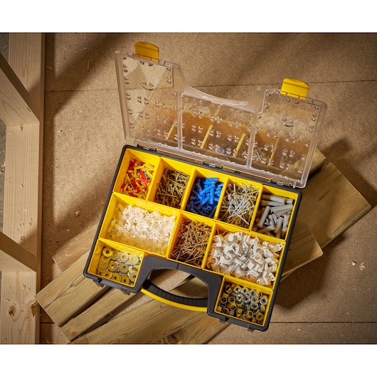 STANLEY 1-92-749 organizer box with assorted fasteners, photographed from above on wooden planks.