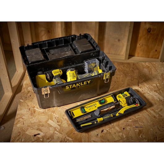 STANLEY 1-94-858 tool box with yellow hand tools and tray, angled view on wooden surface.