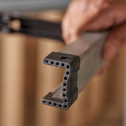 STANLEY 1-97-475 photography of close-up black plastic and metal U-shaped tool frame in hand.