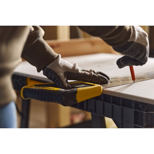 Photo of STANLEY 2-15-288 handsaw with yellow and black handle, used on a workbench for precise cutting.