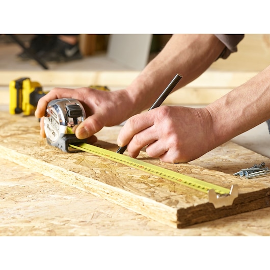 Stanley 5-33-891 tape measure in use on wood, close-up, product photography.