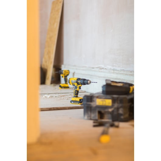 STANLEY FMC626C2K cordless drill photography on construction site, yellow and black tool with accessories.