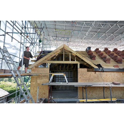 STANLEY FMHT0-36326 photography of construction site with scaffolding and roof building, wide angle view.