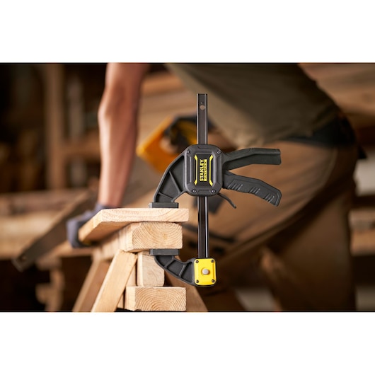 STANLEY FMHT0-83234 clamp holding wood in a workshop, close-up side view.