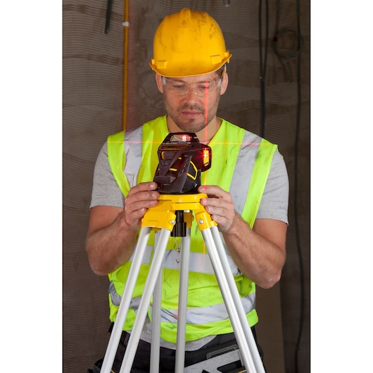 STANLEY FMHT1-77357 laser level on tripod, front angle, used on construction site.
