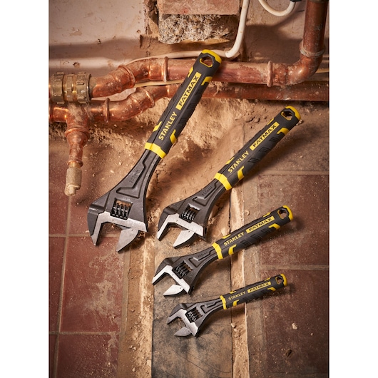STANLEY FMHT13127-0 adjustable wrenches set, black and yellow handles, shown on plumbing site.