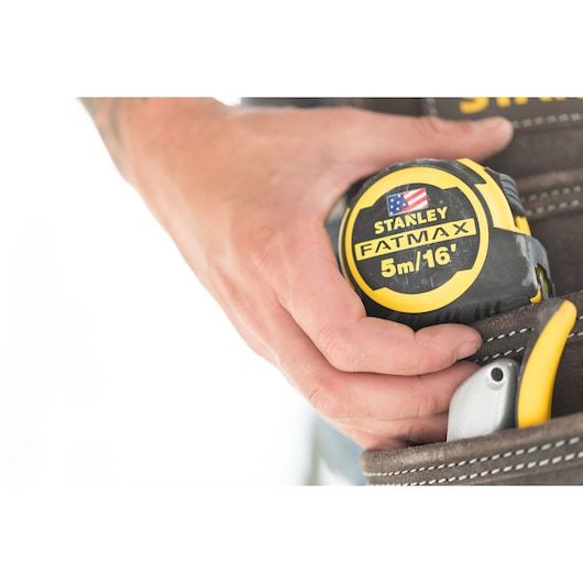 Photo of STANLEY FMHT36317-0 FATMAX 5m/16' tape measure held in a tool belt pouch.