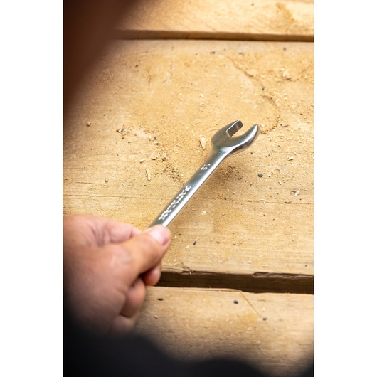 Photo of STANLEY FMMT13029-0 open-ended wrench held over a wooden surface.