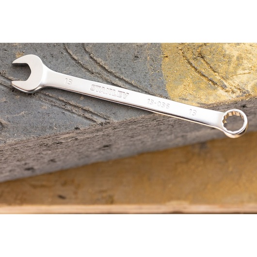 STANLEY FMMT13037-0 combination wrench, silver finish, photographed on a concrete surface.