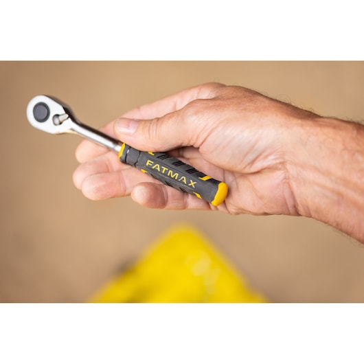 STANLEY FMMT82676-0 ratchet tool with FATMAX handle held in hand, photography close-up.