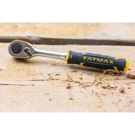 STANLEY FMMT82676-0 ratchet with black and yellow FATMAX handle on wooden surface, side view.