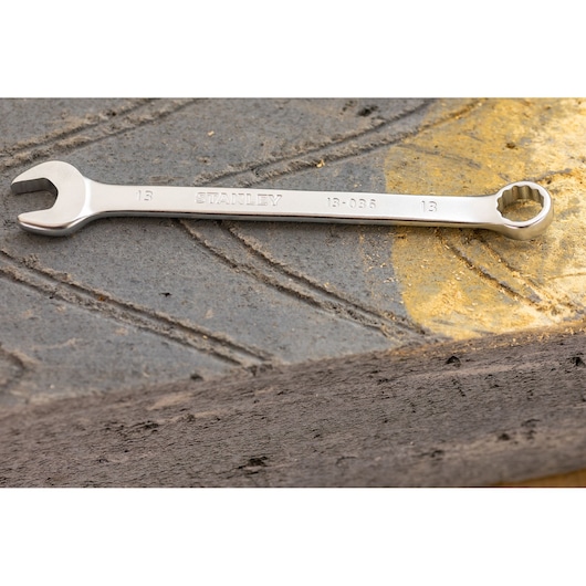 STANLEY FMMT82845-0 combination wrench on textured concrete with yellow paint detail.