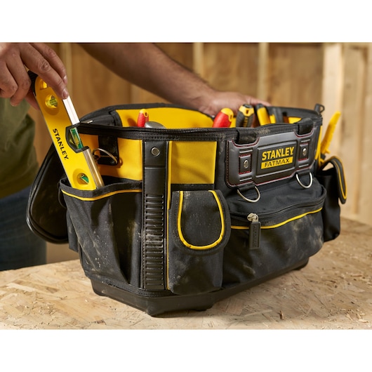 STANLEY FMST1-70749 tool bag with yellow trim filled with hand tools, front angle photo.