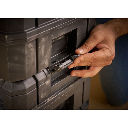 Photo of STANLEY FMST1-71967 toolbox latch being operated by hand, close-up view.