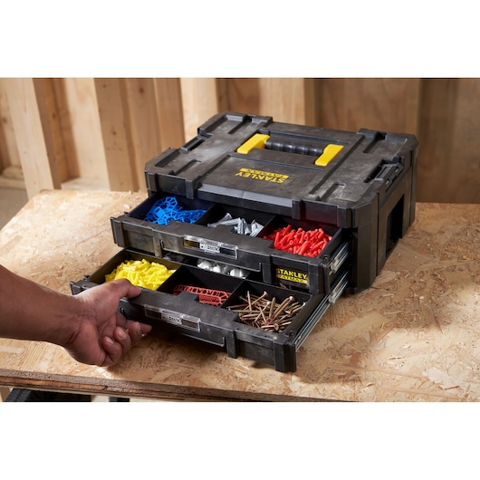 STANLEY FMST1-71969 organizer box with open drawers showing screws and colored fasteners on workbench