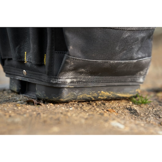 STANLEY FMST17624-1 tool bag base with dirt, close-up view showing rugged black fabric and reinforced bottom.