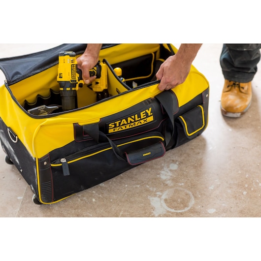 STANLEY FMST82706-1 yellow and black tool bag with handle, photographed open showing tools inside.