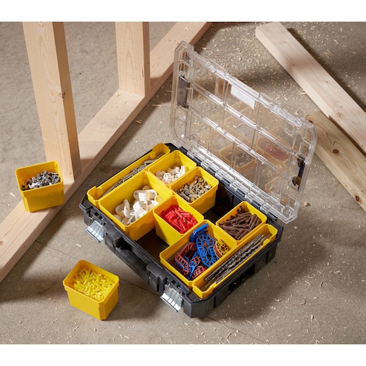 STANLEY FMST82967-9 organizer box with yellow compartments, filled with assorted fasteners, angled view.