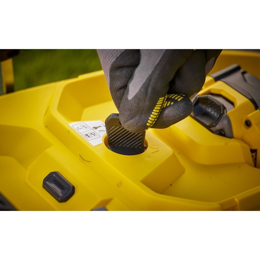 STANLEY SCMWP3401M1-XE lawn mower control knob close-up with gloved hand.