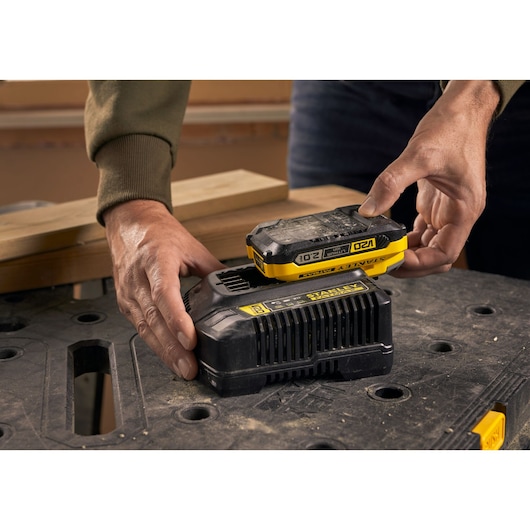 STANLEY SFMCB12D2 battery pack and charger, close-up on workbench.