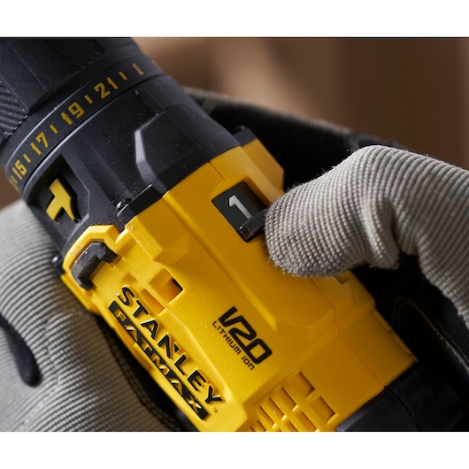 Photo of STANLEY SFMCD711D11 cordless drill V20, close-up of yellow body and gear switch.