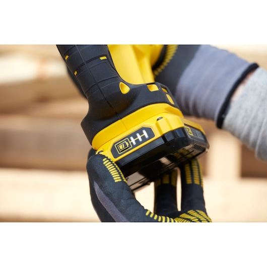 STANLEY SFMCS300D1K photography of cordless tool handle and battery held by gloved hand.