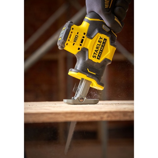 Photo of STANLEY SFMCS305B cordless reciprocating saw in use on wood surface.