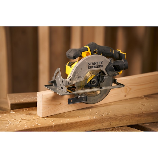 Stanley SFMCS500M1K circular saw cutting wood, side angle, yellow and black power tool.