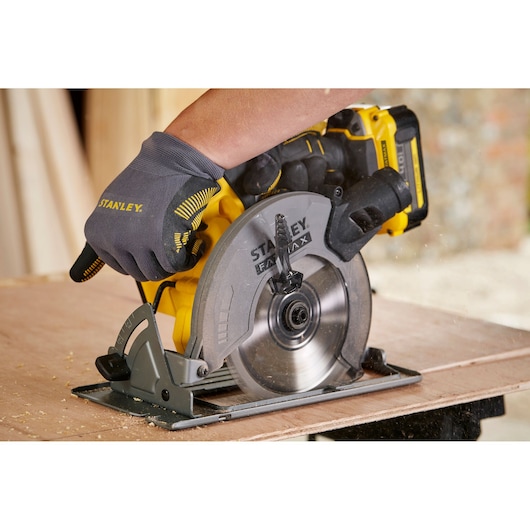 STANLEY SFMCS500M2K photography of cordless circular saw cutting wood, close side angle.