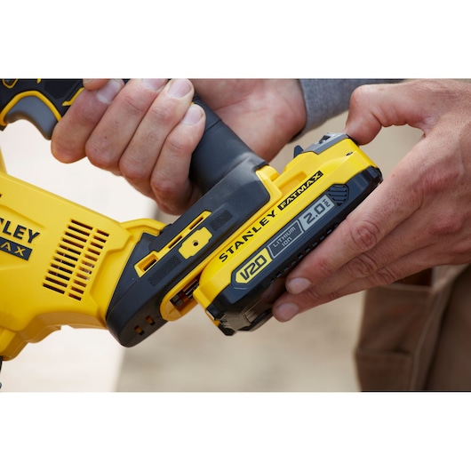 Photo of STANLEY SFMCS600D1K V20 cordless tool with 2.0 Ah lithium-ion battery being inserted.
