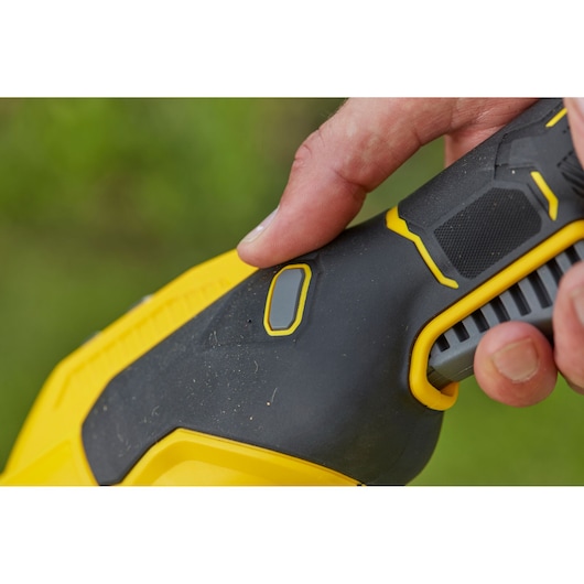 STANLEY SFMCSTB933M photography of black and yellow tool handle with finger pressing grey button.