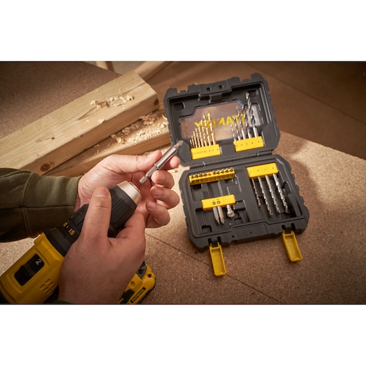 Photo of STANLEY STA88550 drill bit set in black and yellow case with various bits on a workbench.