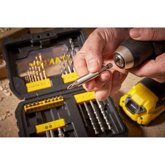 STANLEY STA88550 drill bit set case with drill, close-up of bit being inserted, photography.