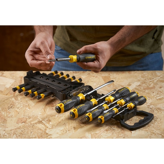 STANLEY STHT0-62144 screwdriver set with yellow and black handles shown on a wooden surface.