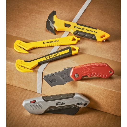 Photo of STANLEY STHT10356-0 utility knives and box cutters on brown cardboard packaging.