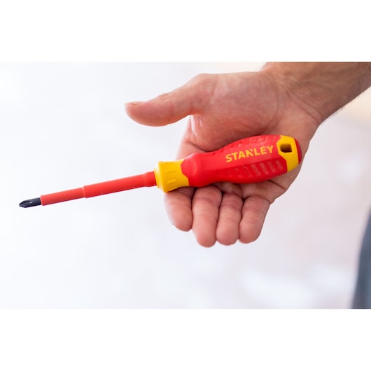 Photo of STANLEY STHT60030-0 red and yellow insulated screwdriver held in hand.