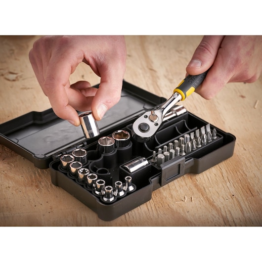 STANLEY STMT82672-0 socket and bit set with ratchet, black case, close-up on wooden surface.