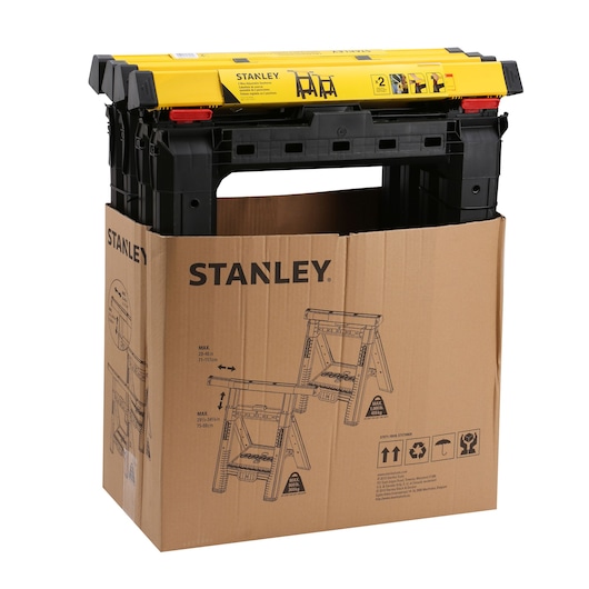 STANLEY STST1-70559 black and yellow plastic sawhorse set in cardboard packaging, front angle.