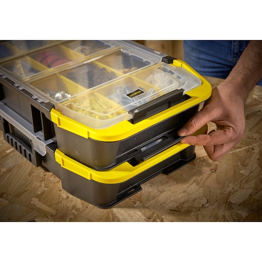 STANLEY STST1-71983 organizer box with yellow trim, transparent lid, shown in use on a wooden surface.
